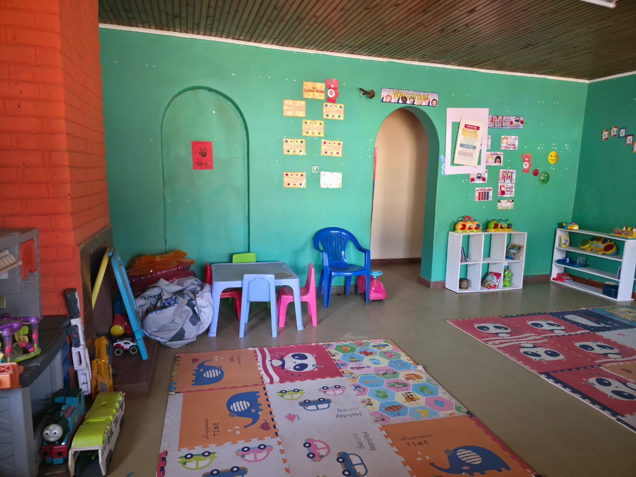 Toddler activity room with tables and learning charts