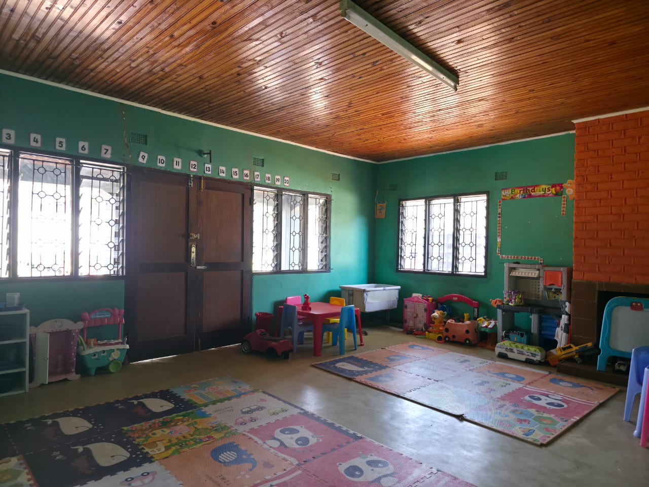 Spacious playroom with soft mats and toys